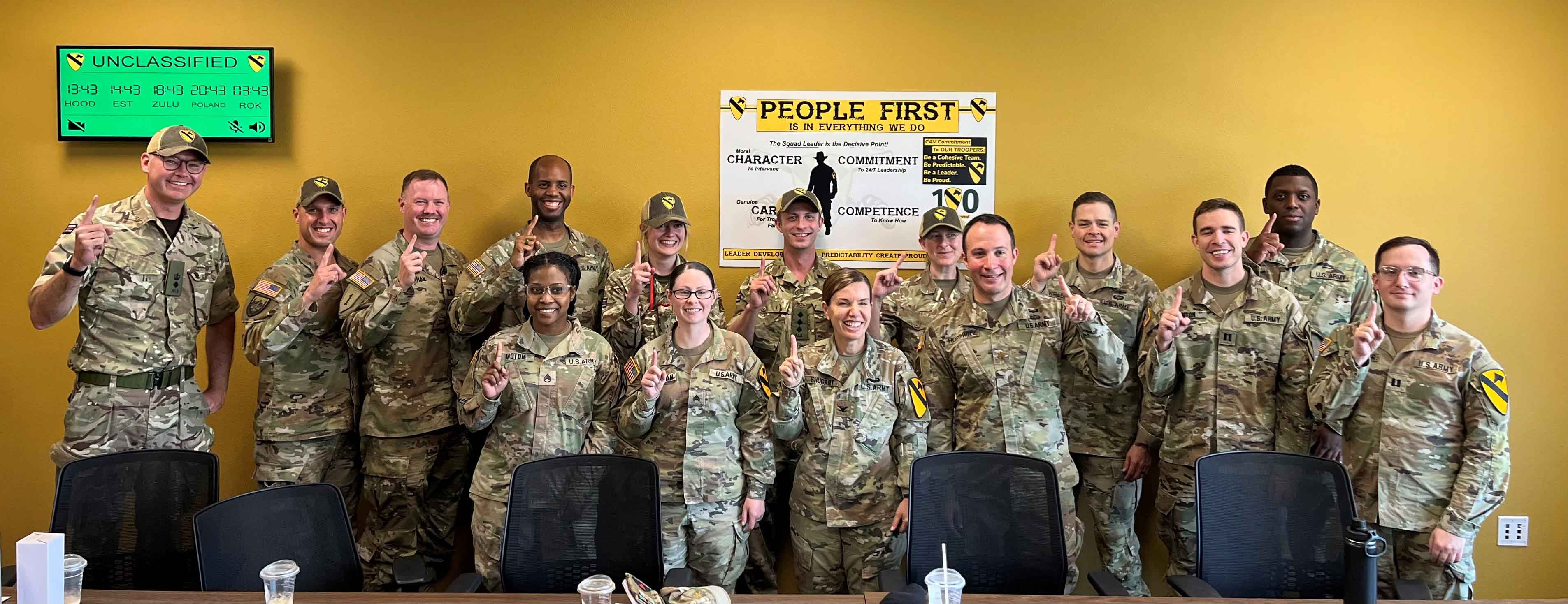 Members of the 3rd United Kingdom Legal Branch (wearing 1st Cavalry Division baseball hats) pose with members of the 1st Cavalry Division Office of the Staff Judge Advocate after Exercise WARFIGHTER 23.4 at Ft. Cavazos, Texas. (Photo courtesy of author)